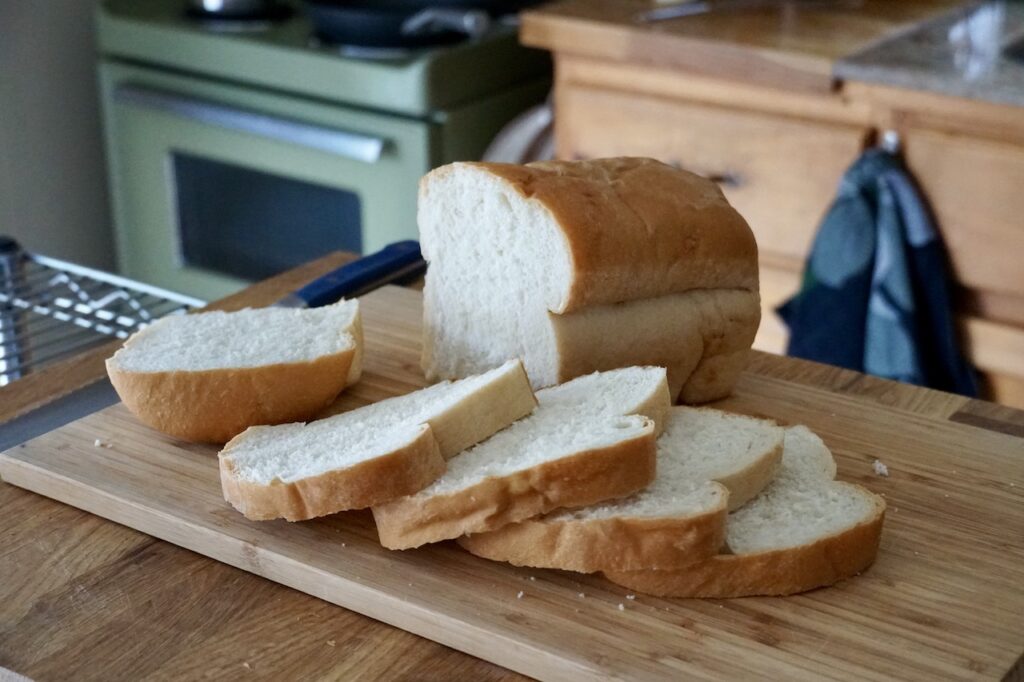 A loaf of country white bread sliced to make sandwiches