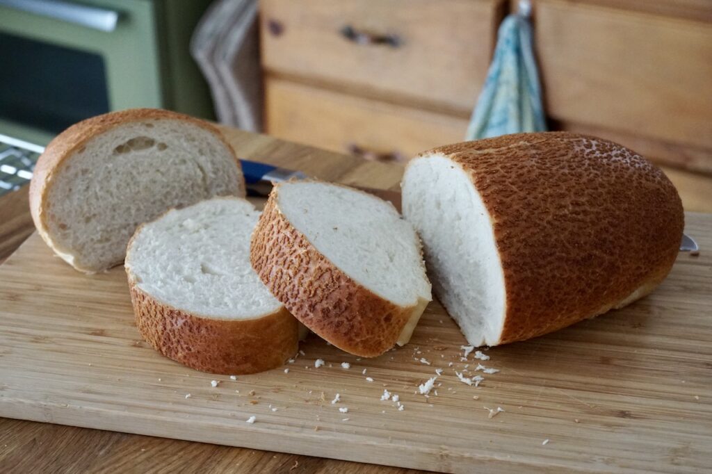 A loaf of sliced crusty Italian bread.