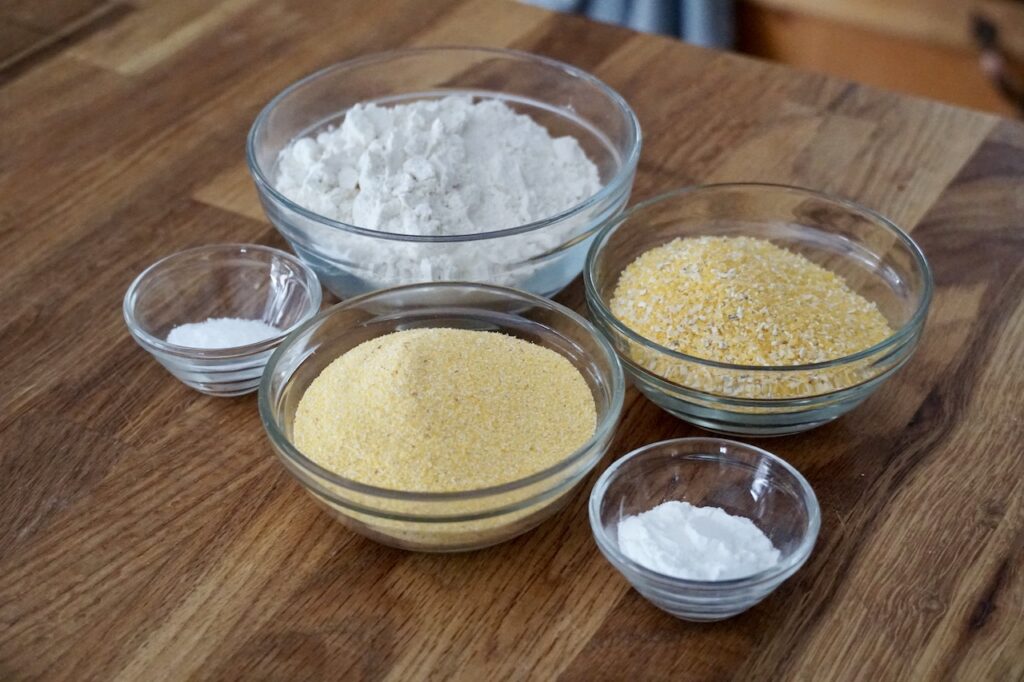 Flour, baking powder and salt plus coarse and fine grind cornmeal.