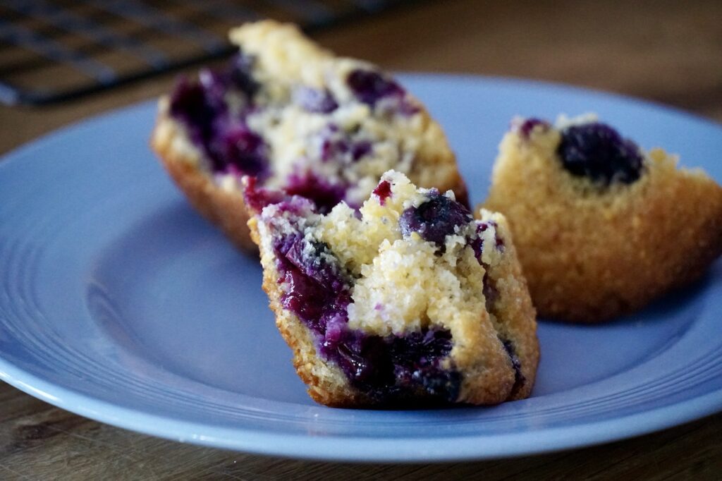 The muffin cracked open to reveal a rich golden colour and fresh blueberries.