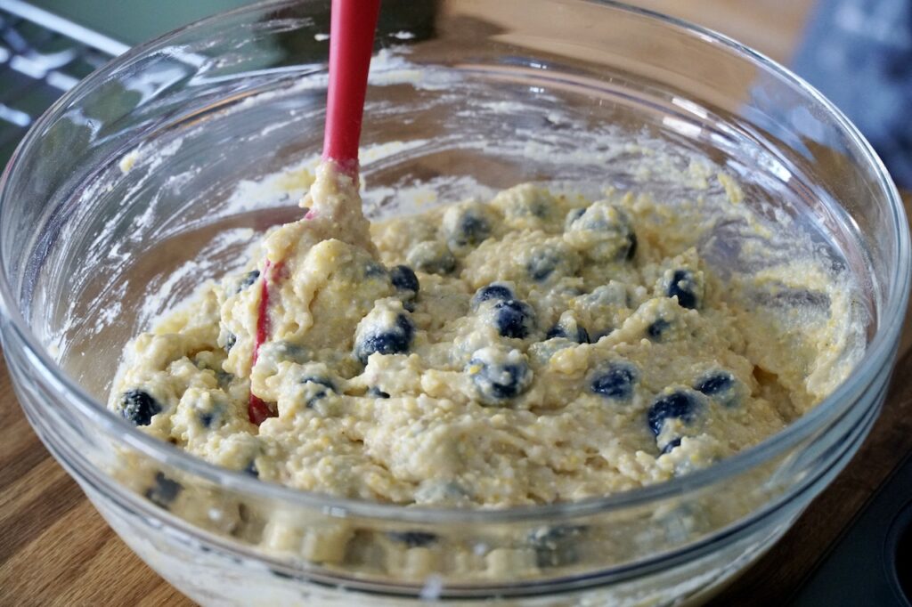 The cornmeal bread batter for the muffins studded with blueberries.