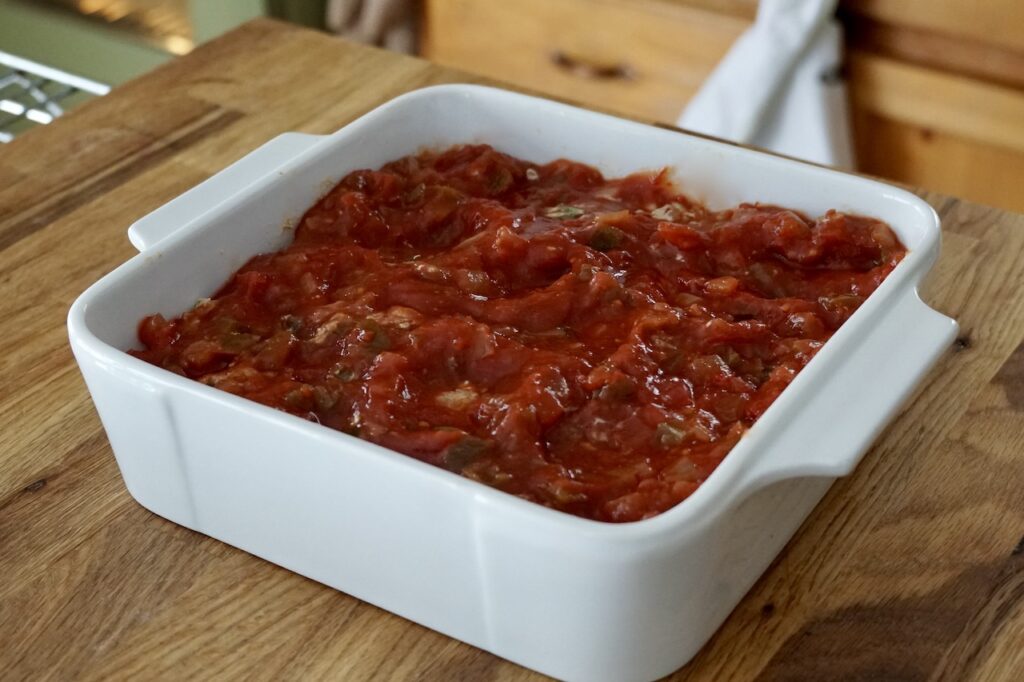 The beef mixture topped with a jar of tomato salsa.
