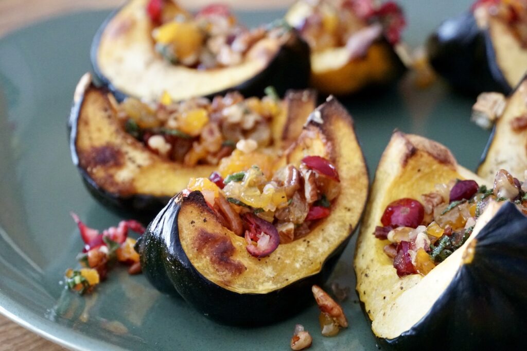 Roasted Acorn Squash presented on a large platter served with sautéed fruit and nuts