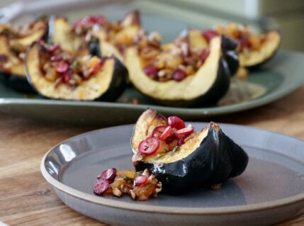 A portion of the oven-baked acorn squash presented on a side plate.