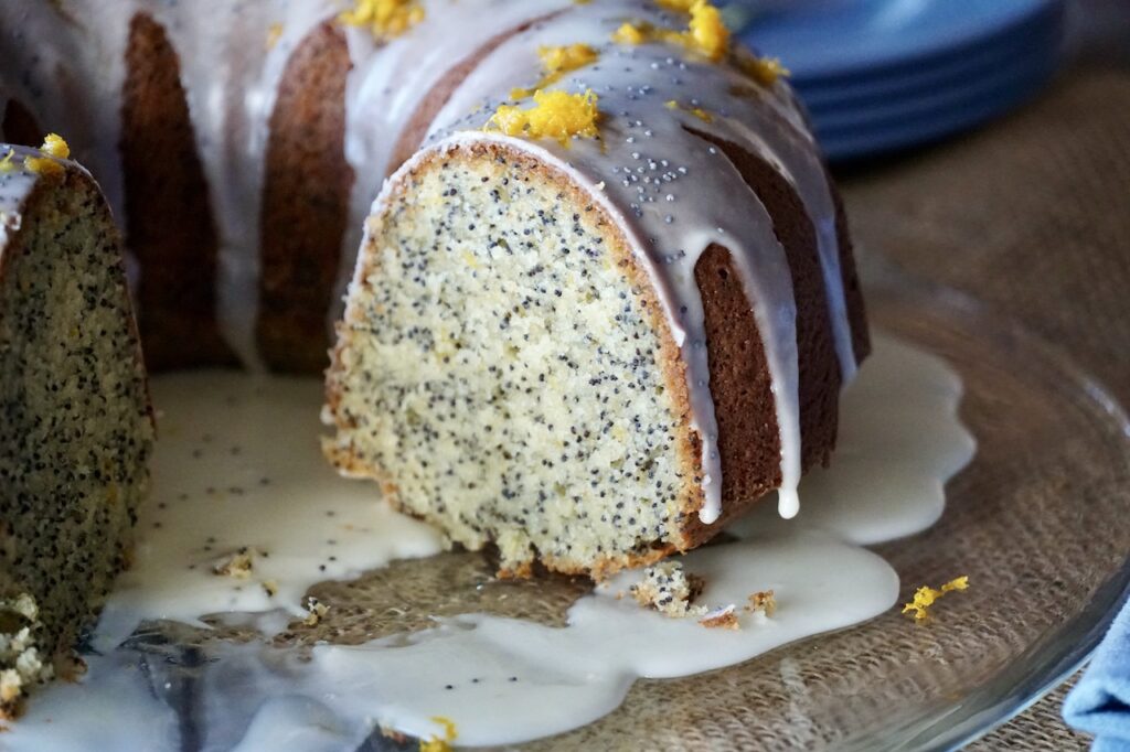 The poppy seed cake sliced, the moist and tender crumb revealed.