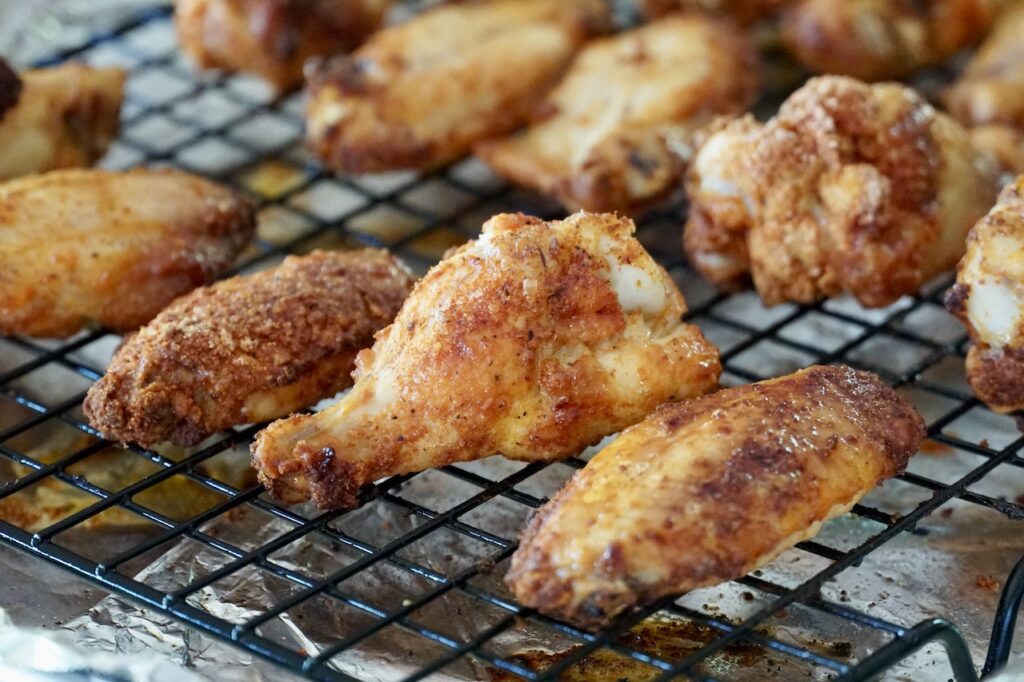 The chicken wings oven-baked crispy on a baking sheet.