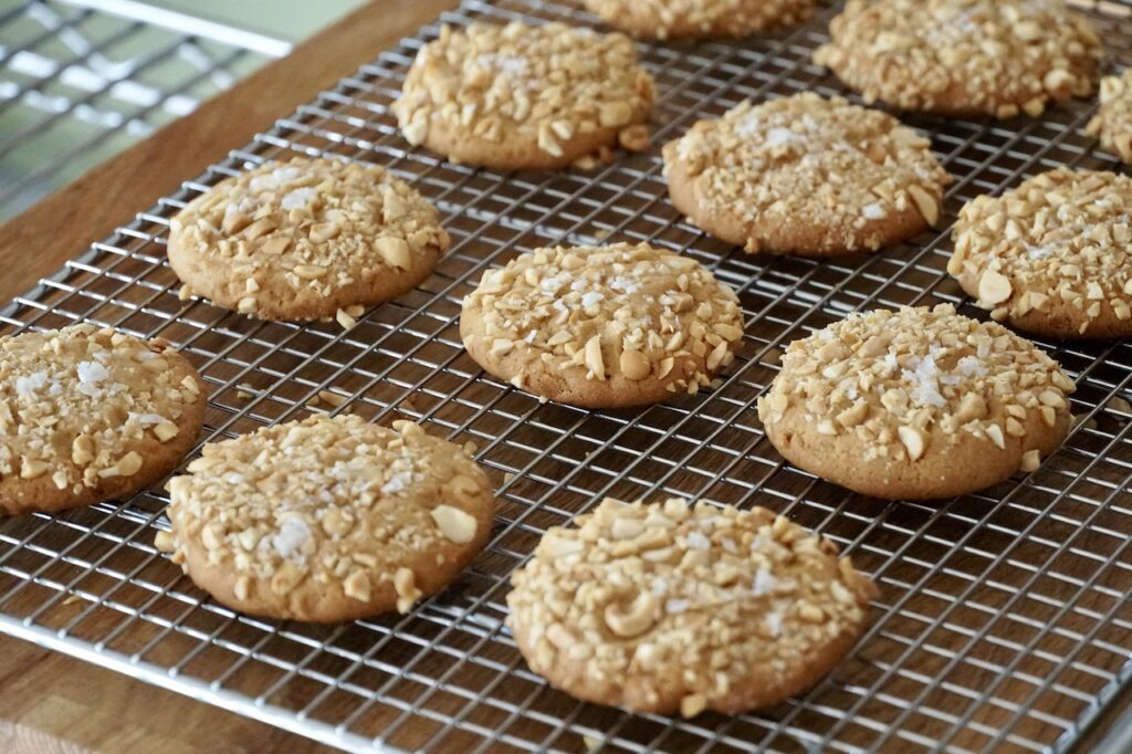 Peanut Butter Cookies topped with chopped, salted peanuts and a sprinkle of seas salt flakes.