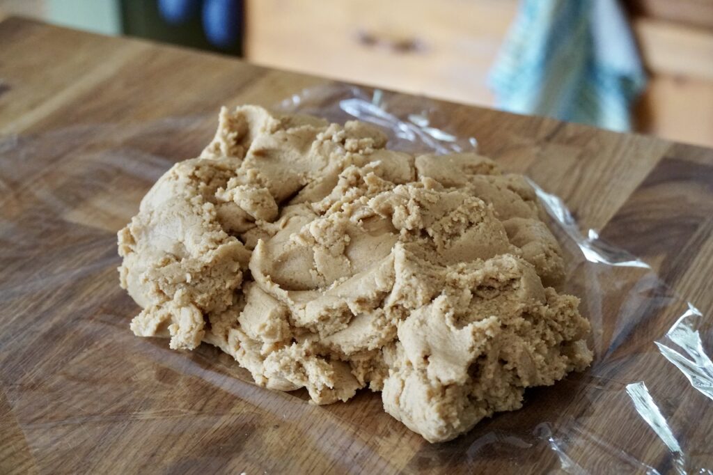 The peanut butter cookie dough resting on a sheet of wrap.