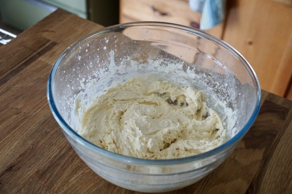 A bowl containing the creamed batter for the cake.