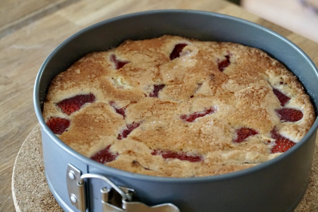 Strawberry rhubarb cake with a rich golden brown colour, fresh out of the oven