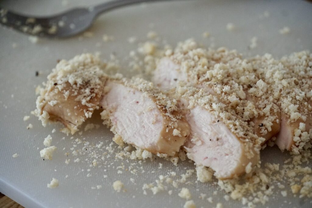 The chicken breasts cut into strips revealing a tender, juicy interior.