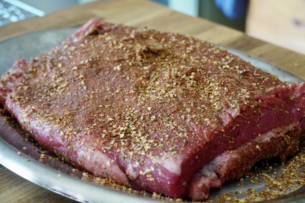 The large piece of beef brisket rubbed with Butcher's Blend spices.