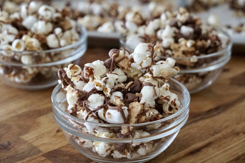 S'Mores Popcorn served in small bowls are perfect for movie night.