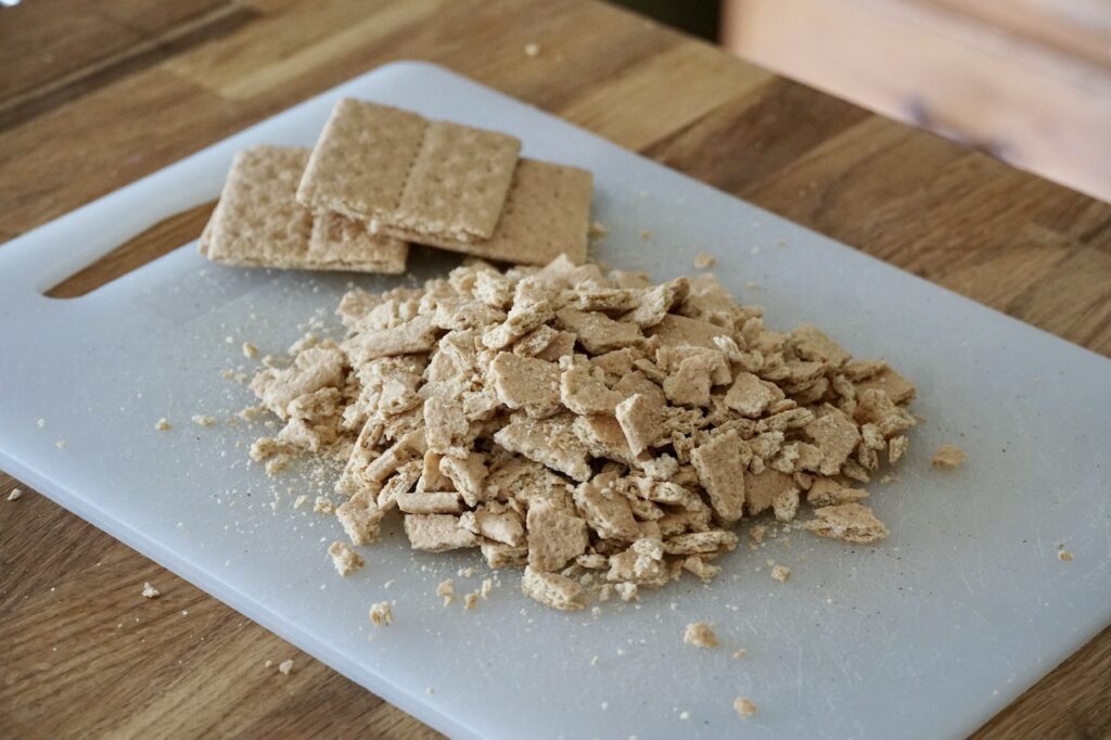 Graham crackers crumbled into small, bite size pieces.