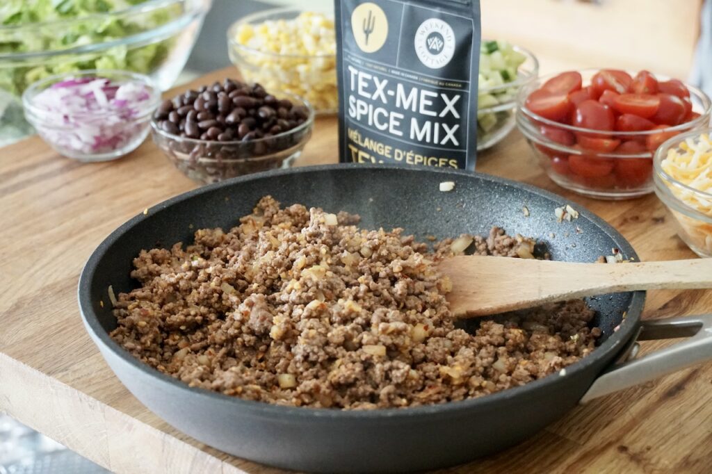 A skillet filled with the sautéed ground beef seasoned with Tex-Mex spice blend.