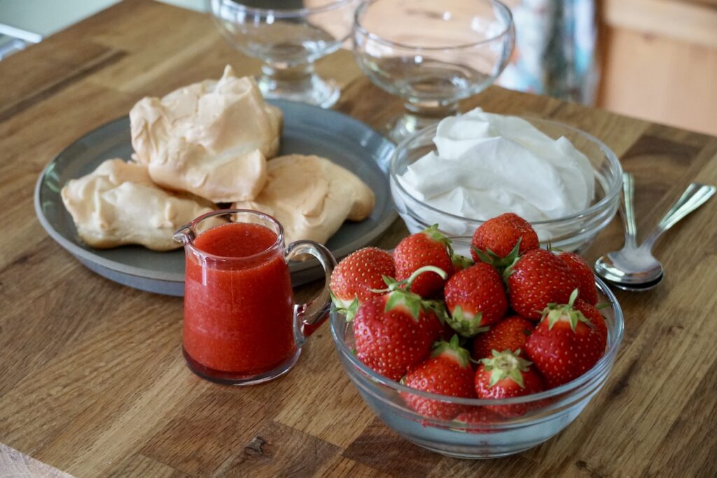 Fresh strawberries, meringues, whipped cream and strawberry coulis.
