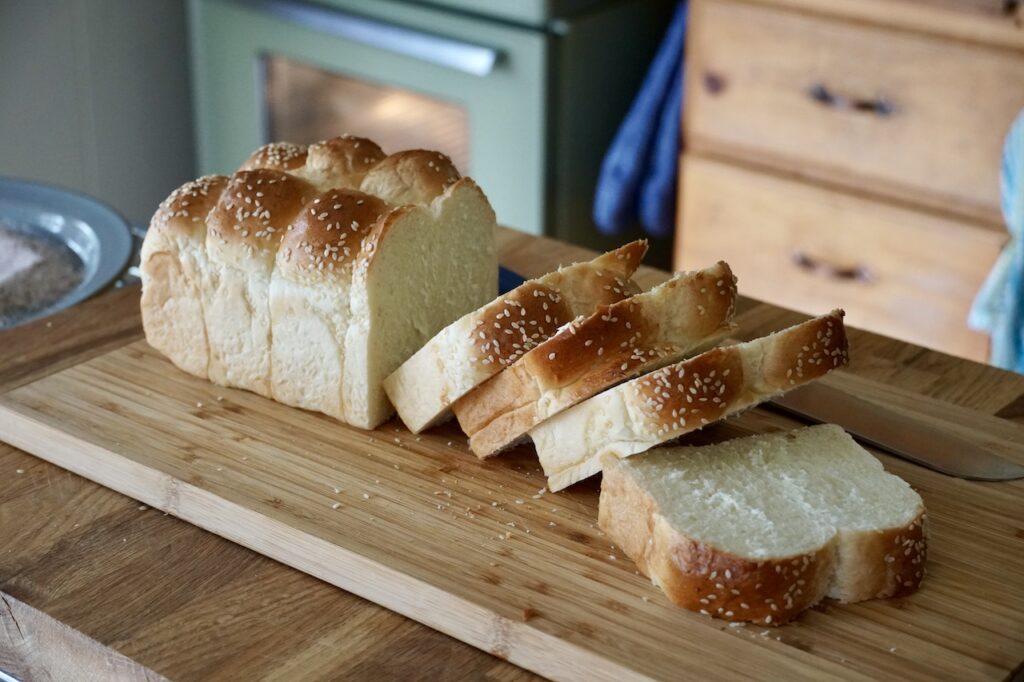 The challah bread cut into thick slices.