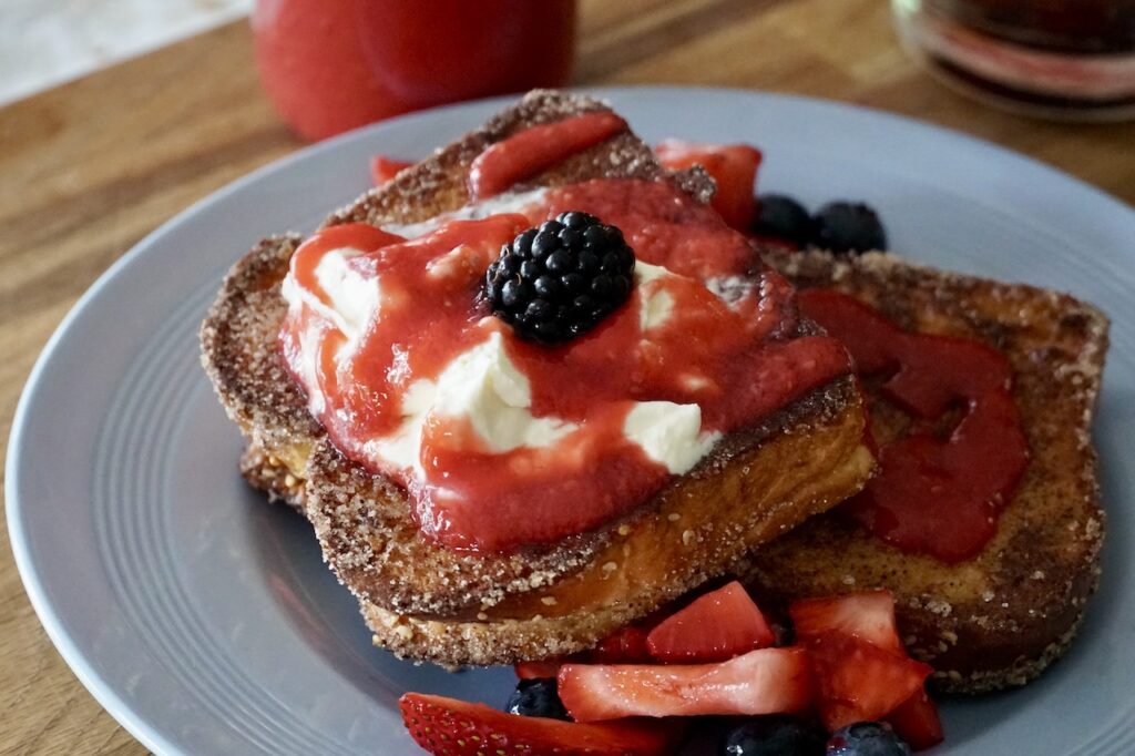 The Perfect French Toast Recipe served with creamy yogurt, berries and a fresh berry syrup.