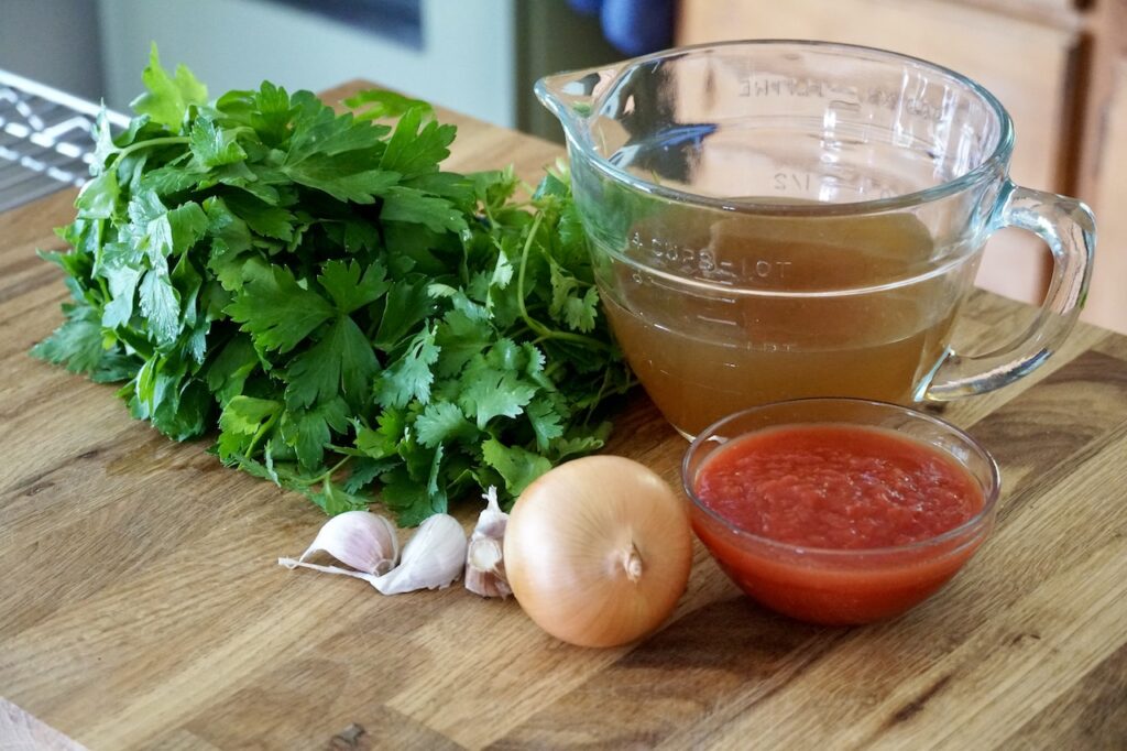 The fresh vegetable components include onion, parsley, garlic plus crushed tomatoes and vegetable broth.
