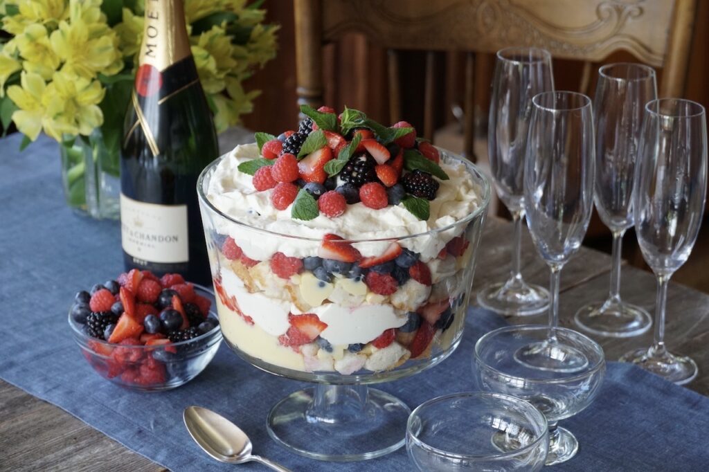 Easy Berry Trifle served on a dessert buffet with champagne.