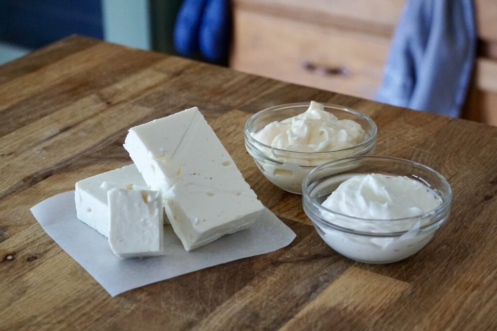 A block of feta cheese, mayonnaise and Greek yogurt.