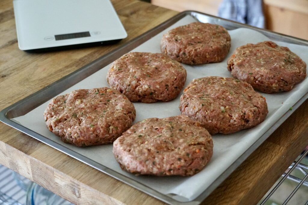 The kofta mixture shaped into 6 hamburger patties.