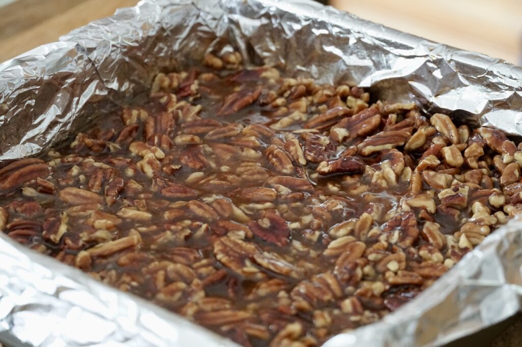 The baking pan filled with the pecan pie squares, ready to be baked.