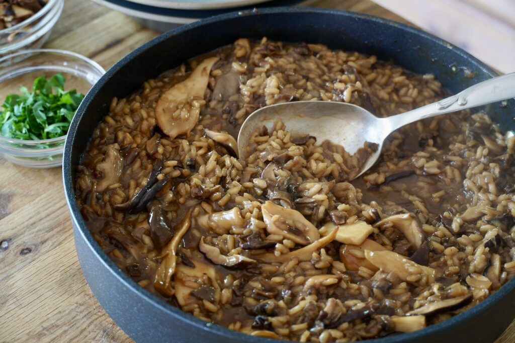 Tghe large skillet filled with the creamy, freshly made Wild Mushroom Risotto.
