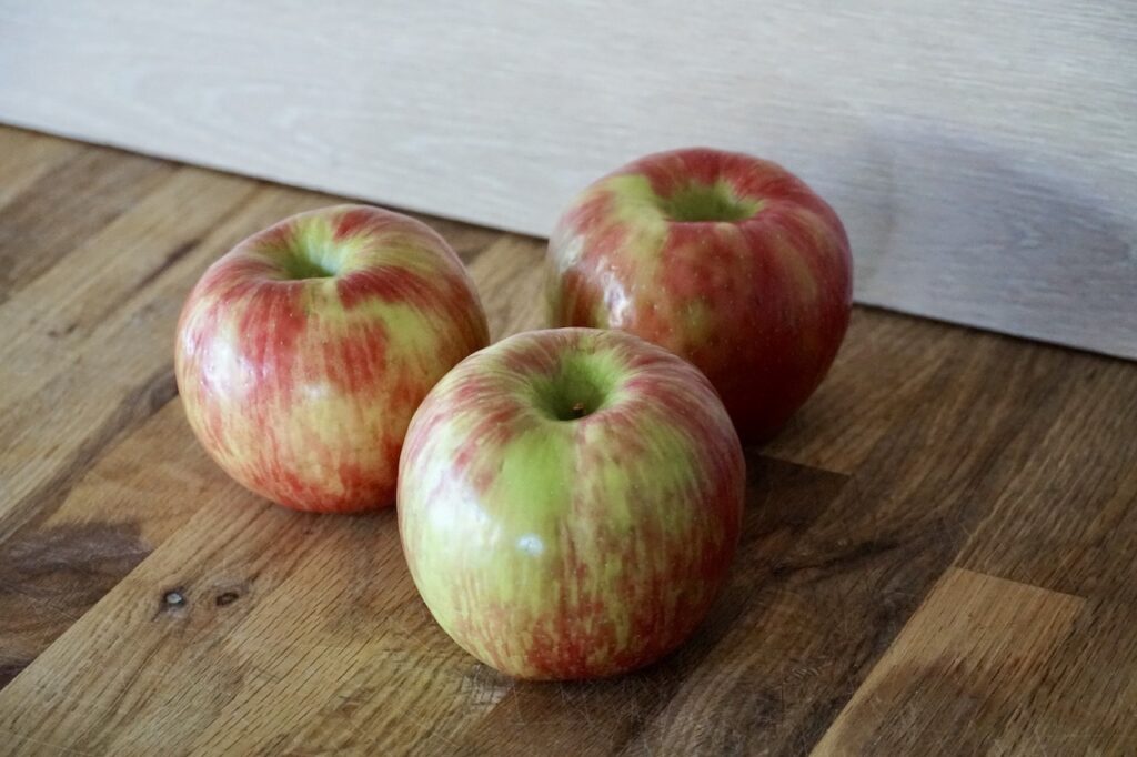Three Honeycrisp apples.
