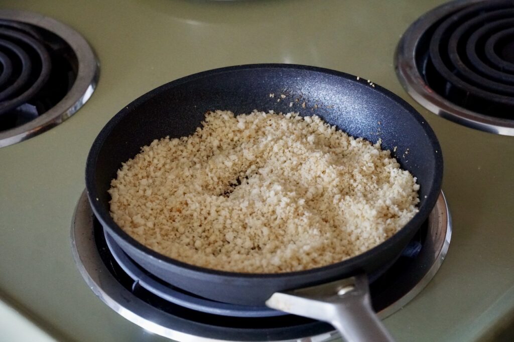 A skillet containing the toasted panko crumbs.