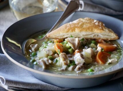 PIN for Leftover Turkey Pot Pie Soup served with a puff pastry triangle.