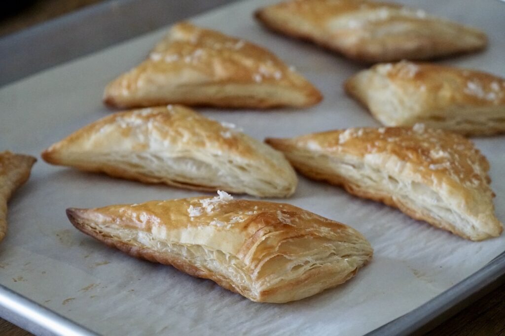Freshly baked puff pastry triangles.