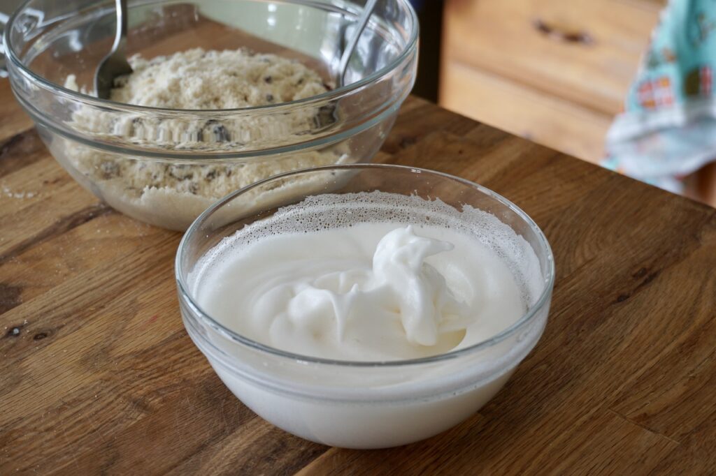 A bowl of egg whites with honey and almond extract.