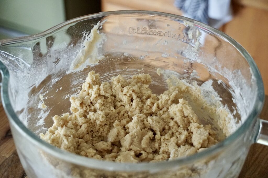 The cookie dough for the thumbprint cookies in a large mixing bowl.