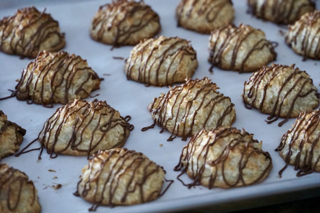 A close up of the macaroons drizzled with chocolate.