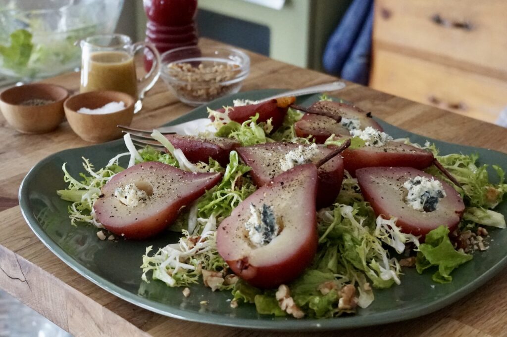 The poached pear salad presented on a large platter.