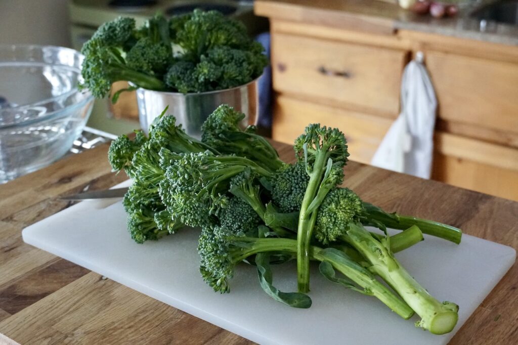 Three bunches of fresh broccolini.