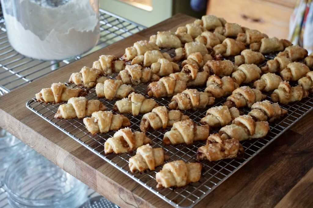 Baked rugelach cooling on a wire rack.