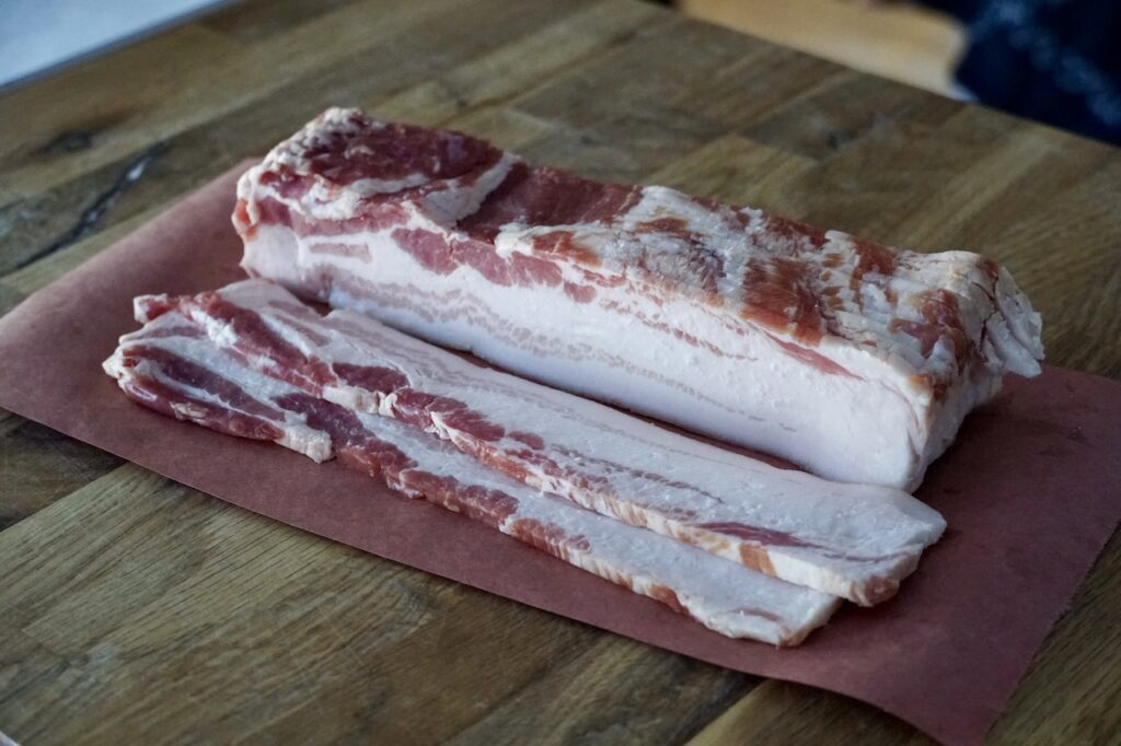 A large slab of thick sliced bacon.