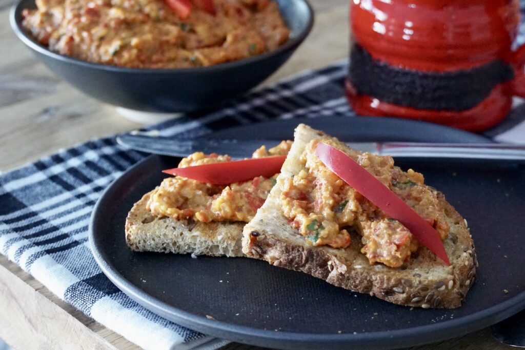 Roasted Red Pepper Dip served on buttered toast.