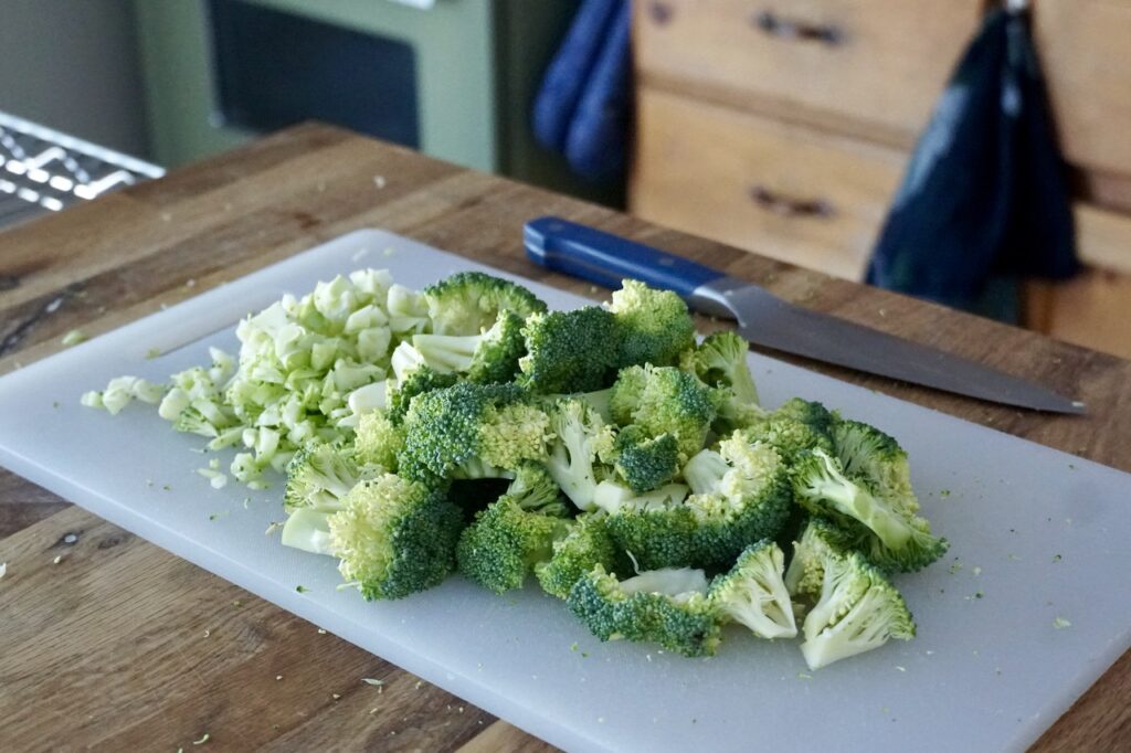 Fresh broccoli chopping into small chunks and florets.