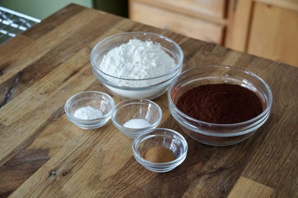 Bowls of flour, cocoa powder, kosher salt and instant espresso powder.