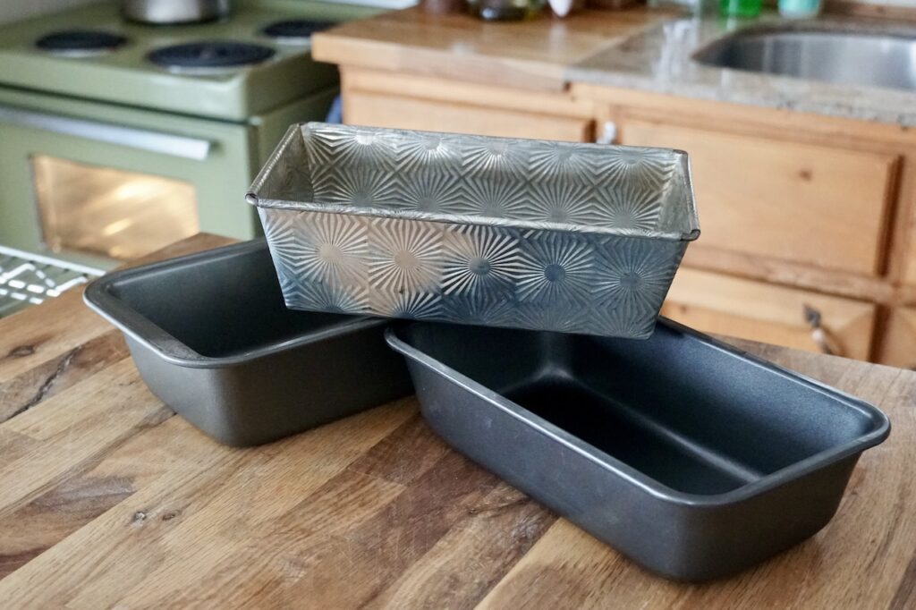 Three loaf pans stacked together.