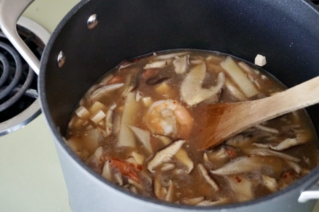 The hot and sour soup assembled with the shrimp, tofu and bamboo shoots floating within.