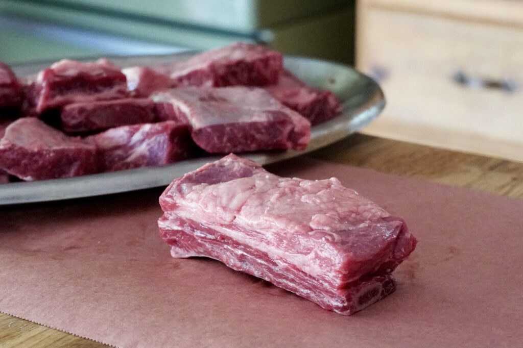 A beef short rib before being trimmed and deboned.