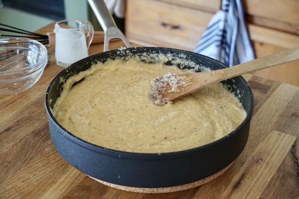 The finished skillet containing the creamy polenta.