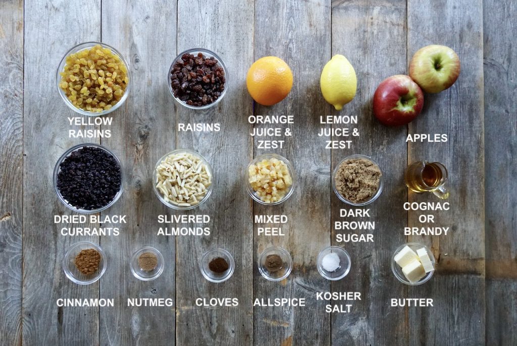 All of the ingredients needed to make homemade mincemeat assembled in little bowls spread out on our work surface.