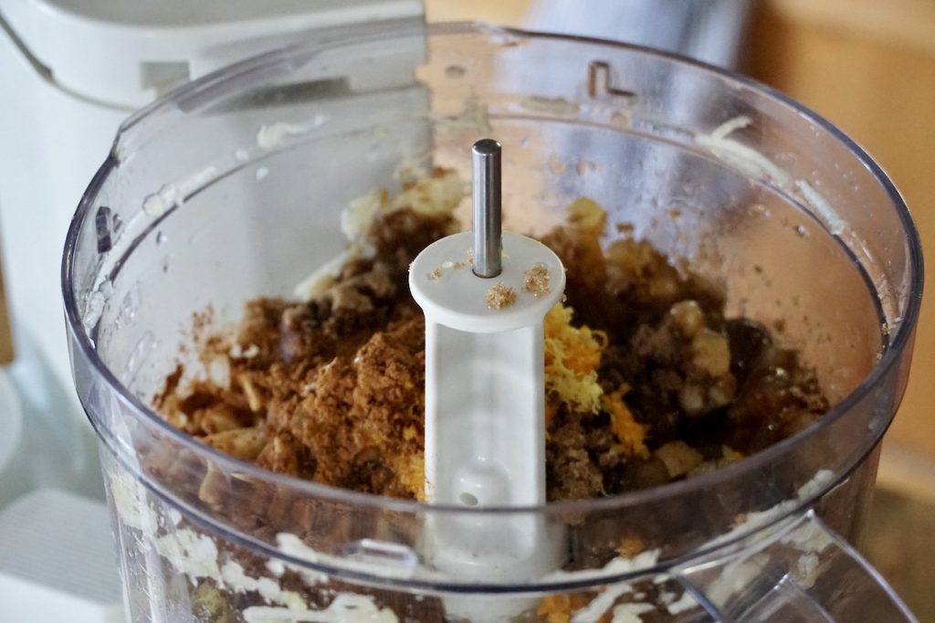 The various ingredients spilled into the canister of a food processor.