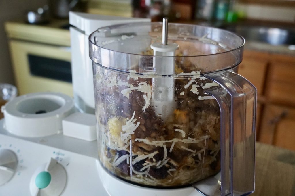 The ingredients ready to be minced by the blade of the processor.