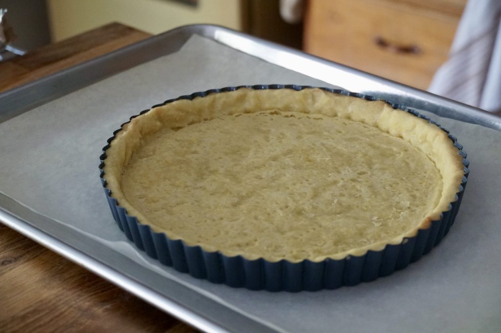 The pie shell after 15 minutes, the foil and weights removed.